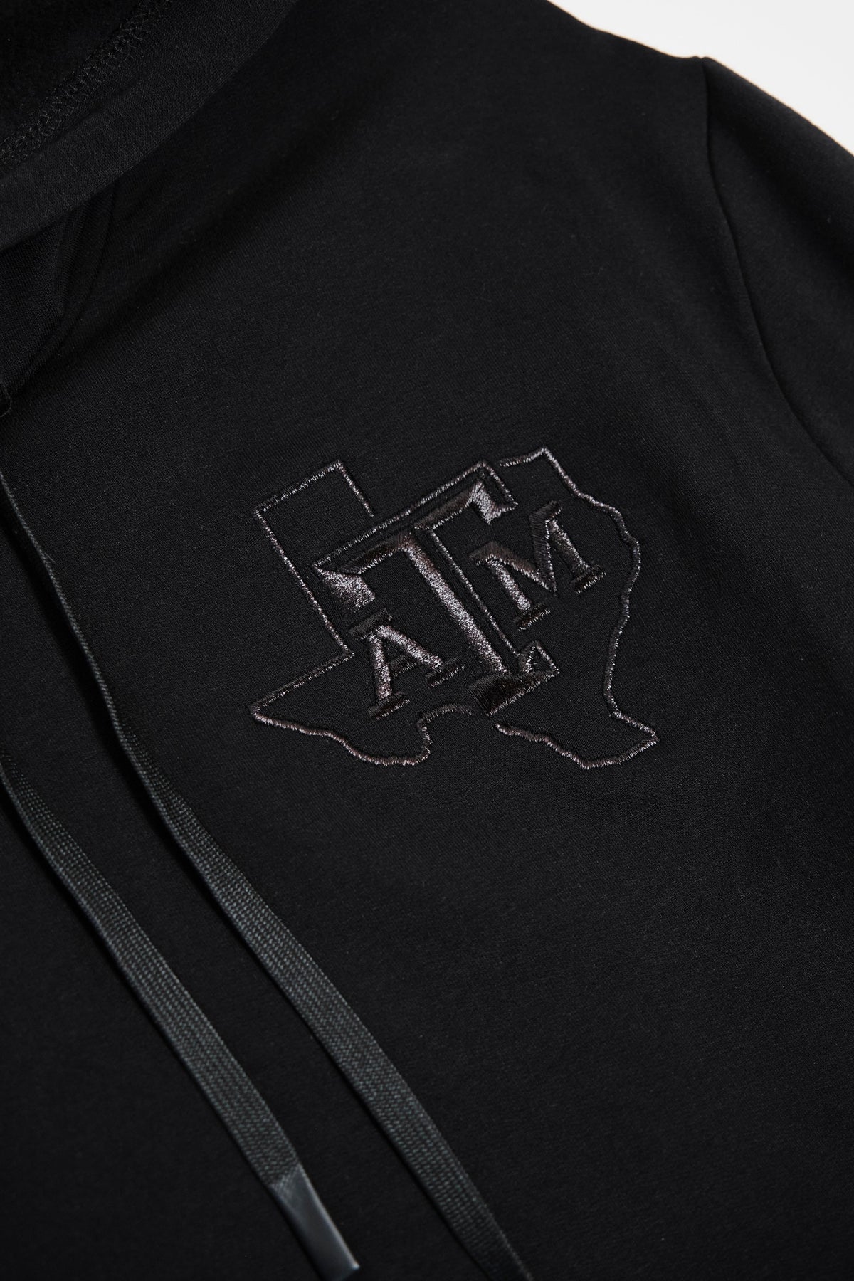 Tonal Texas A&M embroidery on black fabric