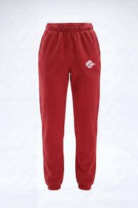 Red sweatpants with an elastic waistband and cuffs, featuring a small white logo on the upper right hip, displayed against a light gray background.