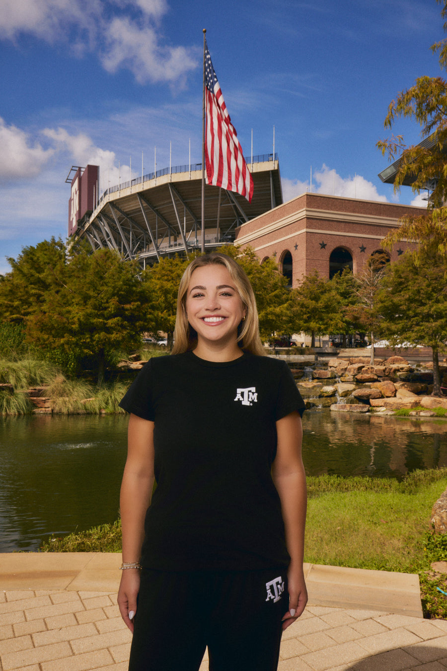 young woman wear texas A&M black tee and sweatpants set from AVO