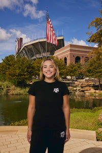 young woman wear texas A&M black tee and sweatpants set from AVO
