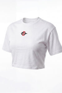 A white short-sleeve cropped t-shirt with a small red and black graphic logo on the left chest, displayed on a clean white background.
