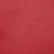 A close-up of a solid red textured surface, likely a fabric or material swatch.