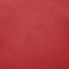 A close-up of a solid red textured material, likely leather or suede.