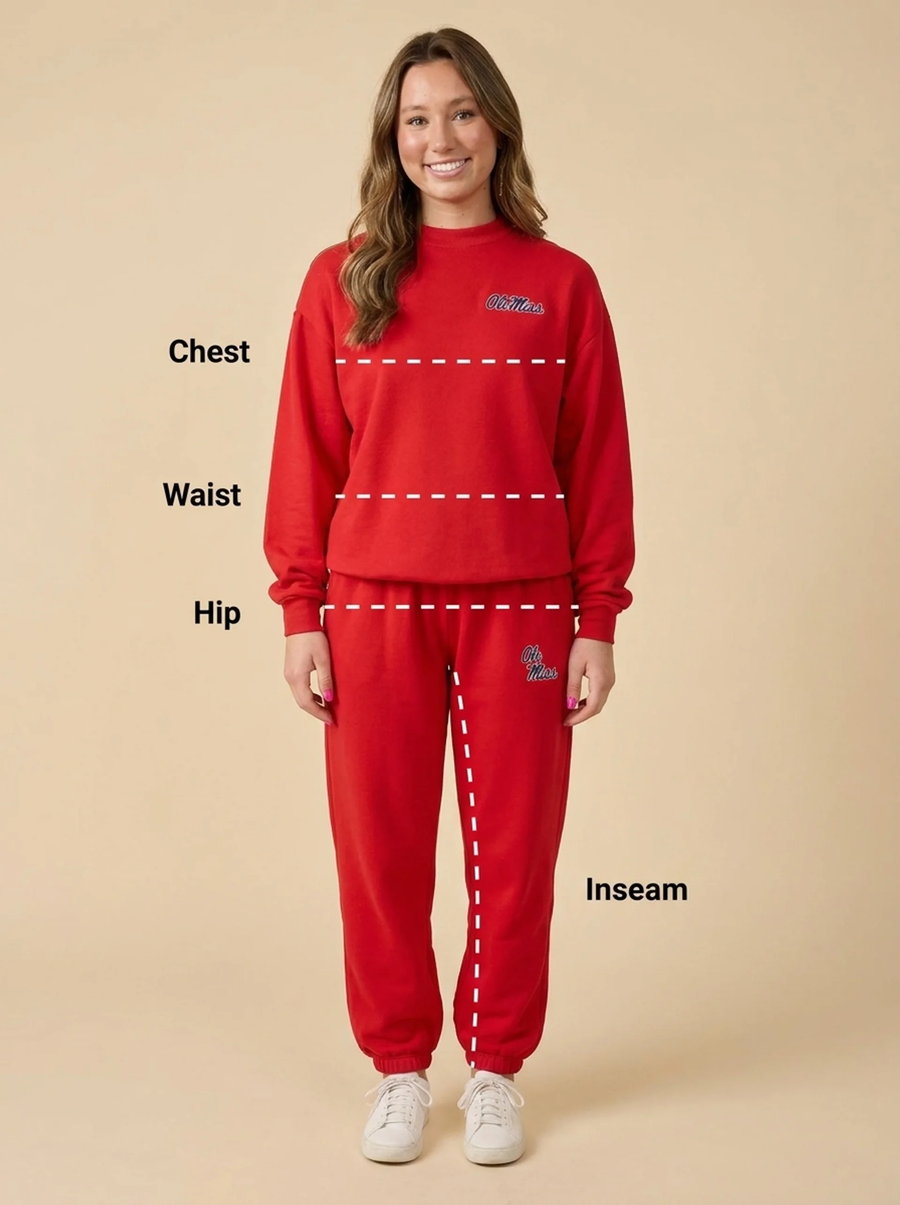 A woman modeling a red sweatshirt and matching sweatpants against a beige studio background, with white dashed lines and text labels marking chest, waist, hip, and inseam measurements.